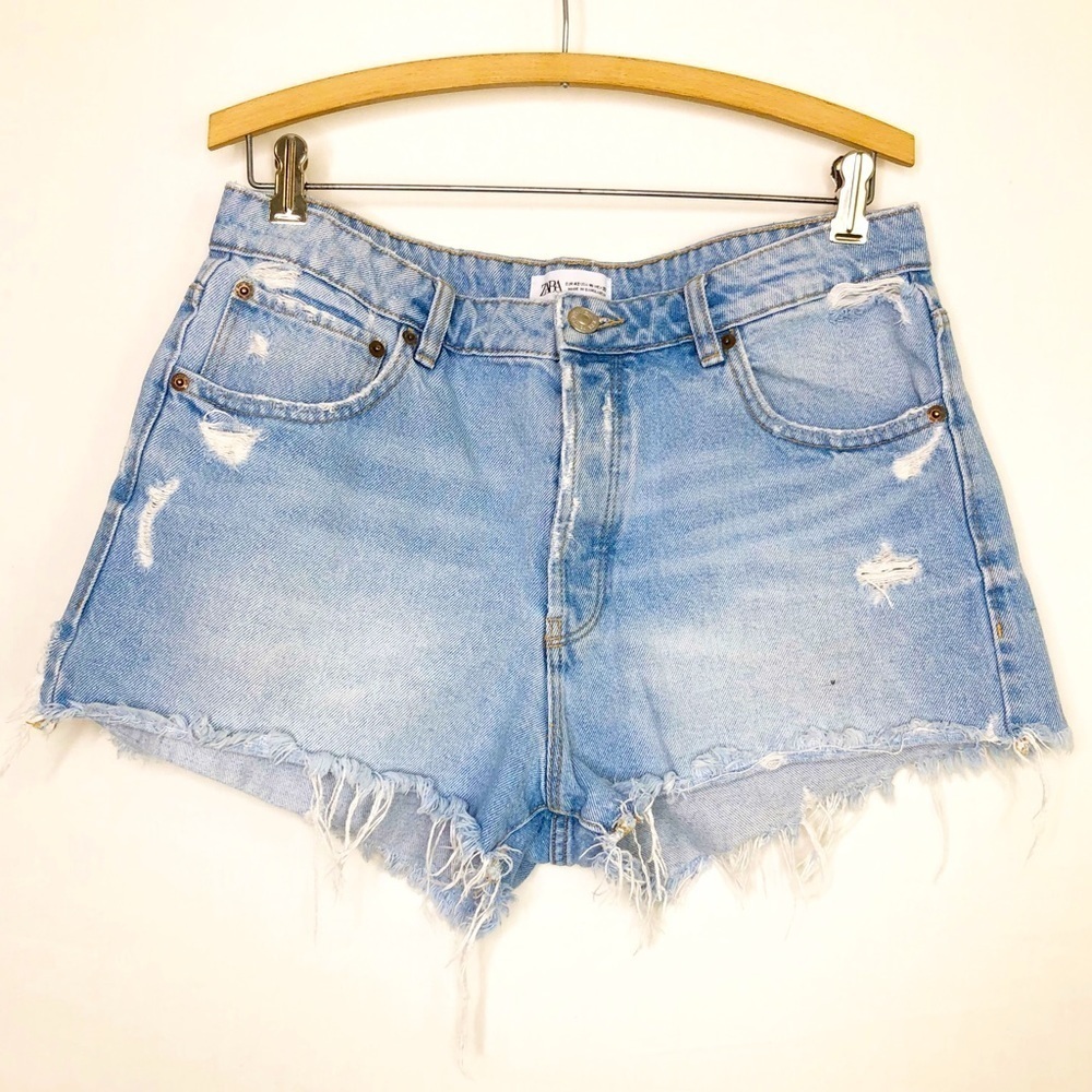 Zara light wash, distressed frayed hem button fly shorts.